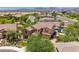 Aerial view captures a lovely home, pool, lush landscaping, and mountain backdrop, in a tranquil neighborhood at 3760 W Lapenna Dr, New River, AZ 85087