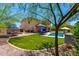 Large backyard with artificial turf, desert landscaping, pavers, and an outdoor dining area at 3760 W Lapenna Dr, New River, AZ 85087