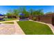 Backyard with manicured lawn, desert landscaping, pavers, outdoor dining area, and built in BBQ at 3760 W Lapenna Dr, New River, AZ 85087