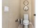 This bathroom features a toilet, a tiled floor and tan walls at 3760 W Lapenna Dr, New River, AZ 85087