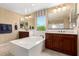 This bathroom offers dual vanities, a neutral color scheme, and lots of natural light at 3760 W Lapenna Dr, New River, AZ 85087
