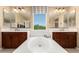 This bathroom offers dual vanities, neutral color scheme, and a large garden tub at 3760 W Lapenna Dr, New River, AZ 85087