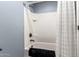Tiled tub-shower combination with bronze fixtures and white shower curtain at 3760 W Lapenna Dr, New River, AZ 85087