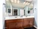 This bathroom offers dual sinks, a large mirror and wood cabinetry at 3760 W Lapenna Dr, New River, AZ 85087