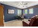 Bedroom featuring a ceiling fan, three windows and a work area at 3760 W Lapenna Dr, New River, AZ 85087
