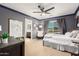 This bedroom has neutral carpeting, a ceiling fan and blue accents at 3760 W Lapenna Dr, New River, AZ 85087