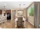 Dining area featuring wood floors, a modern chandelier and lots of natural light at 3760 W Lapenna Dr, New River, AZ 85087
