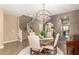 Elegant dining room featuring a modern chandelier, staircase and wood floors at 3760 W Lapenna Dr, New River, AZ 85087