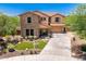 Charming two-story home featuring stone accents, a well-manicured lawn, and inviting curb appeal at 3760 W Lapenna Dr, New River, AZ 85087