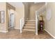Grand foyer features hardwood floors, staircase with white railing, and charming decor elements at 3760 W Lapenna Dr, New River, AZ 85087