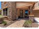Inviting covered front porch featuring stone columns and manicured landscaping at 3760 W Lapenna Dr, New River, AZ 85087