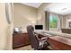 Convenient home office with custom built-ins, desk, and plenty of natural light at 3760 W Lapenna Dr, New River, AZ 85087