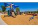 Community playground features a covered playset, a slide, and a blue seesaw, great for outdoor activities at 3760 W Lapenna Dr, New River, AZ 85087