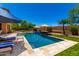 Backyard pool and patio with umbrellas and lounge chairs at 3760 W Lapenna Dr, New River, AZ 85087