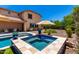 Backyard features a sparkling pool, spa, patio furniture, and lush landscaping, perfect for outdoor entertaining at 3760 W Lapenna Dr, New River, AZ 85087