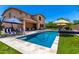 Inviting backyard featuring a pool, covered patio seating and a grassy yard at 3760 W Lapenna Dr, New River, AZ 85087