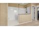 This shower features a glass enclosure and tan tiled walls at 3760 W Lapenna Dr, New River, AZ 85087