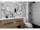 Sleek bathroom features a vanity, toilet, and shower with modern black and white design at 4117 E Coolidge St, Phoenix, AZ 85018