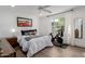 Bright bedroom with a bed, exercise bike, wood floors, and natural light from the window at 4117 E Coolidge St, Phoenix, AZ 85018