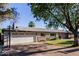 Exterior view of single Gathering house with lawn and mature trees at 4117 E Coolidge St, Phoenix, AZ 85018