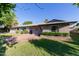 Exterior view of single story house with brick accents and driveway at 4117 E Coolidge St, Phoenix, AZ 85018