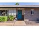 Charming home featuring a bright blue front door and well-maintained landscaping at 4117 E Coolidge St, Phoenix, AZ 85018