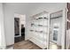 Hallway featuring a decorative shelf and a view into the bathroom and office at 4117 E Coolidge St, Phoenix, AZ 85018