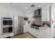 Well-equipped kitchen featuring stainless steel appliances and sleek white cabinets at 4117 E Coolidge St, Phoenix, AZ 85018