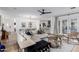 Open concept living area with hardwood floors, modern furniture, and a view into the kitchen and dining area at 4117 E Coolidge St, Phoenix, AZ 85018