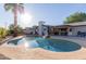 The backyard has a pool and patio ideal for outdoor entertaining, plus mature landscaping at 4117 E Coolidge St, Phoenix, AZ 85018