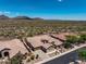 Beautiful aerial view of a desert home with tile roof, natural landscaping, and mountain views at 41809 N La Crosse Trl, Anthem, AZ 85086