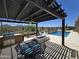 Outdoor kitchen and pergola with seating area, a sparkling pool and mountain views at 41809 N La Crosse Trl, Anthem, AZ 85086