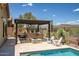 Outdoor kitchen with a grill, a fire pit, pool and desert views in the backyard at 41809 N La Crosse Trl, Anthem, AZ 85086