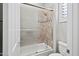 Modern bathroom featuring a tub with tiled walls and a sliding glass door at 41809 N La Crosse Trl, Anthem, AZ 85086
