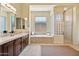 Spacious bathroom features a soaking tub, a separate glass block shower and dual sinks at 41809 N La Crosse Trl, Anthem, AZ 85086