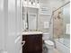 Bathroom with a single vanity, shower-tub, and toilet features modern fixtures and tile accents at 41809 N La Crosse Trl, Anthem, AZ 85086