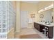Large bathroom features dark cabinets, double sinks, glass block shower, and soaking tub at 41809 N La Crosse Trl, Anthem, AZ 85086