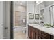 Bright bathroom with a single sink, framed mirror, shower, and toilet with modern fixtures at 41809 N La Crosse Trl, Anthem, AZ 85086