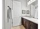 Bathroom with vanity featuring a single sink, framed mirror, and a door leading to the toilet at 41809 N La Crosse Trl, Anthem, AZ 85086