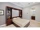 Bedroom with a Murphy bed, built-in shelving, and an en-suite bathroom, offering space-saving and stylish living at 41809 N La Crosse Trl, Anthem, AZ 85086