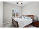 Bright bedroom offers carpet, ceiling fan, and shuttered windows providing ample sunlight at 41809 N La Crosse Trl, Anthem, AZ 85086