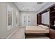Bright bedroom featuring shuttered windows, a Murphy bed, and neutral tones, creating a versatile living space at 41809 N La Crosse Trl, Anthem, AZ 85086