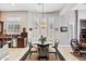 Dining space with big windows, stylish light fixture, and furniture adjacent to kitchen at 41809 N La Crosse Trl, Anthem, AZ 85086