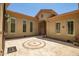 Spacious courtyard with decorative inlaid tile and tan stucco exterior at 41809 N La Crosse Trl, Anthem, AZ 85086