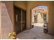 Inviting courtyard entrance with decorative planters and secured entry door at 41809 N La Crosse Trl, Anthem, AZ 85086