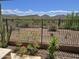 Scenic desert view with cacti and mountain views with iron fence, showcasing the property's natural surroundings at 41809 N La Crosse Trl, Anthem, AZ 85086