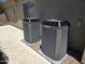 Exterior shot of two modern AC units situated outside a home with desert landscaping at 41809 N La Crosse Trl, Anthem, AZ 85086