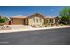 Beautiful single-story home with a three car garage, desert landscaping, and a tile roof at 41809 N La Crosse Trl, Anthem, AZ 85086