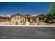 Charming single-story home with desert landscaping, stone accents, and a tiled walkway to the front door at 41809 N La Crosse Trl, Anthem, AZ 85086