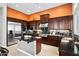 Gourmet kitchen featuring stainless steel appliances, dark wood cabinetry, and center island at 41809 N La Crosse Trl, Anthem, AZ 85086